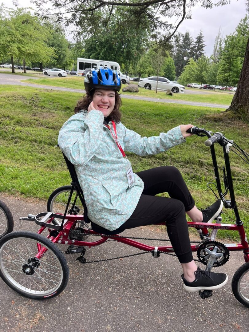 A woman riding on the back of a bike.